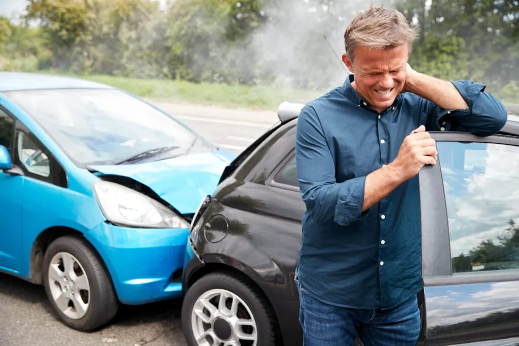 Physiotherapist assessing a patient's neck range of motion after a motor vehicle accident